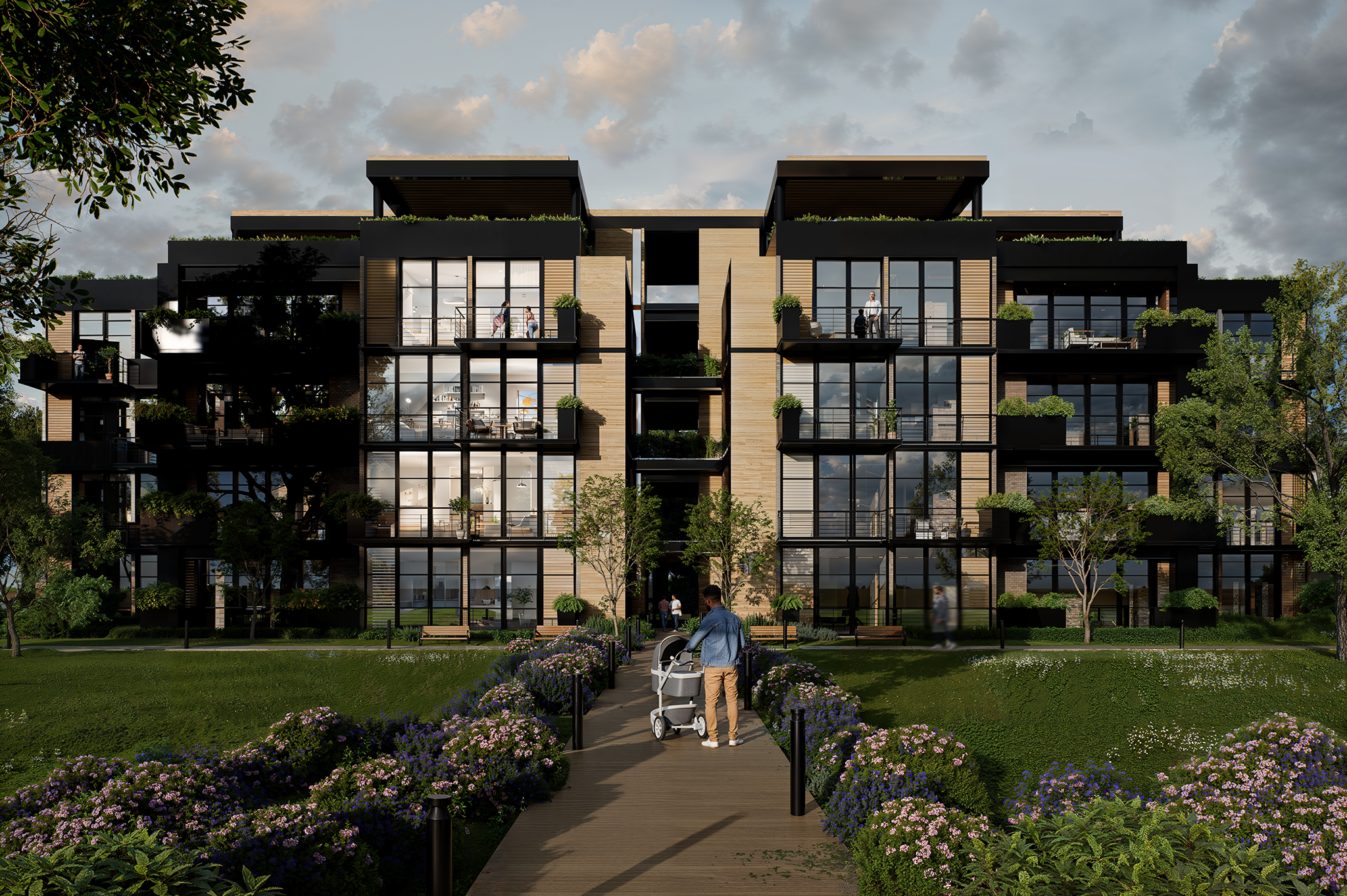 Une personne avec une poussette marche sur un sentier en direction des Terrasses du Parc, un immeuble d'appartements moderne de quatre étages avec de grandes baies vitrées, des balcons, de la verdure et des parterres de fleurs devant, par une journée partiellement nuageuse.